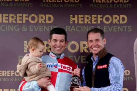 Smiling Robbie Dunne celebrates first winner back after bully ban with baby daughter at Hereford